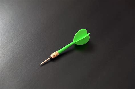 Premium Photo Green Dart Arrow On Black Background