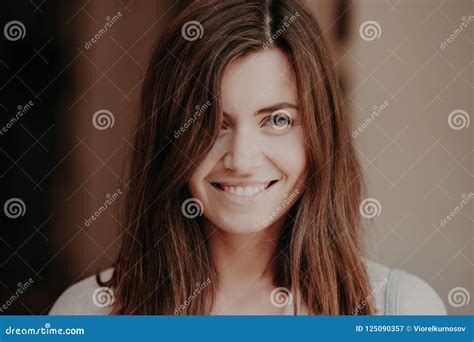 Close Up Portrait Of Happy Brunette Woman With Toothy Smile Looks