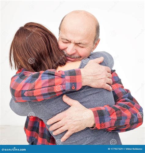 Adult Daughter And Older Hispanic Father Hugging And Cuddling Stock