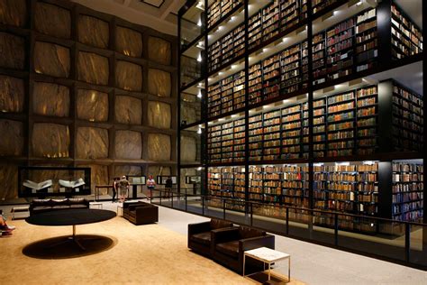 A Library Filled With Lots Of Books On Shelves Next To A Wall Full Of Books