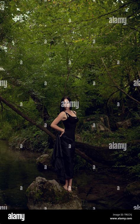 Beautiful Brunette Girl In A Dark Fairy Forest Stock Photo Alamy