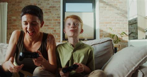 Mom And Son Play Video Games Using Joysticks Stock Video Video Of