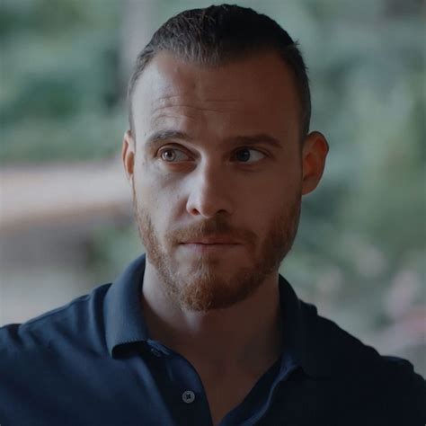 A Close Up Of A Person Wearing A Blue Shirt And Looking At The Camera