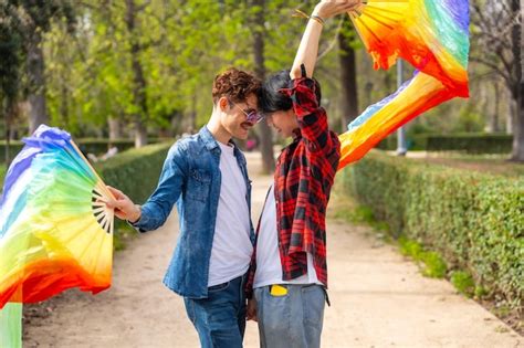 Premium Photo Multiethnic Gay Couple Dancing Using Rainbow Fans