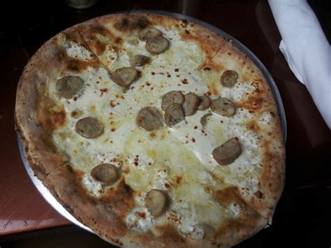 Individual Quattro Formaggi Pizza With Sausage At Via Napoli In Italy