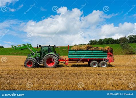 A Tractor Pulling a Hay Wagon with a Field Behind it Stock Photo - Image of traction, trailer ...