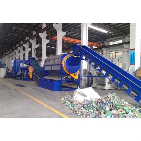 An Assembly Line In A Factory Filled With Plastic Bottles And Other