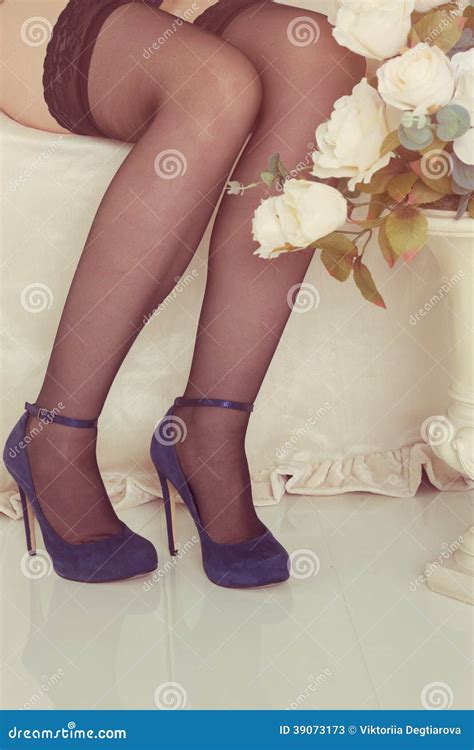 Legs On Bed With Fishnet Stockings And Heel Shoes Stock Photo Image