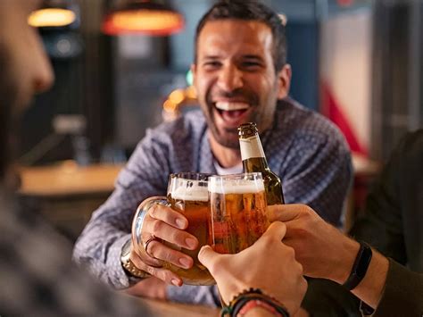 People Drinking Beer At Bar