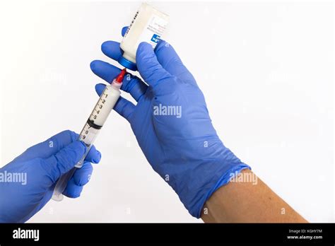 Left Handed Anesthesiologist Withdrawing Propofol Into A Syringe