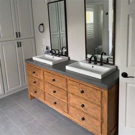 Two Sinks And Mirrors In A Bathroom With Gray Tile On The Floor Along