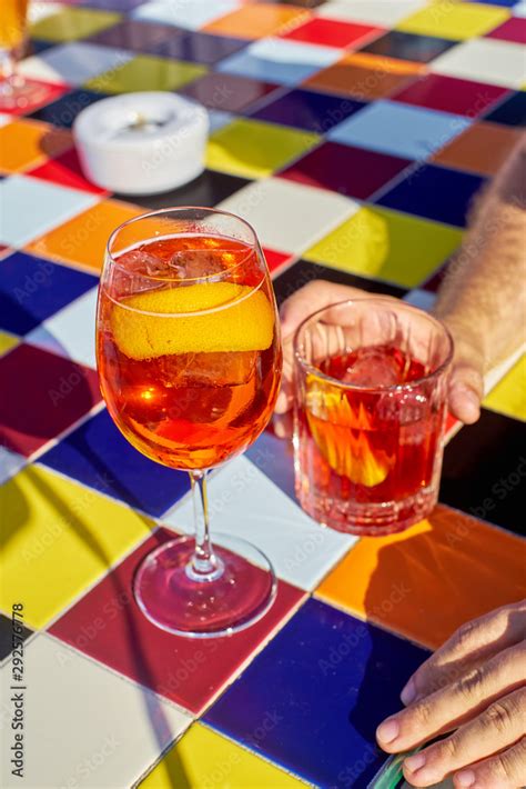 Aperol Spritz Cocktail And Negroni On Colorful Tiled Table Stock Photo