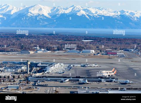 Anchorage Airport terminal aerial view in Alaska with mountain behind. Ted Stevens Anchorage ...