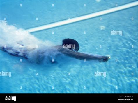 Man swimming underwater Stock Photo - Alamy