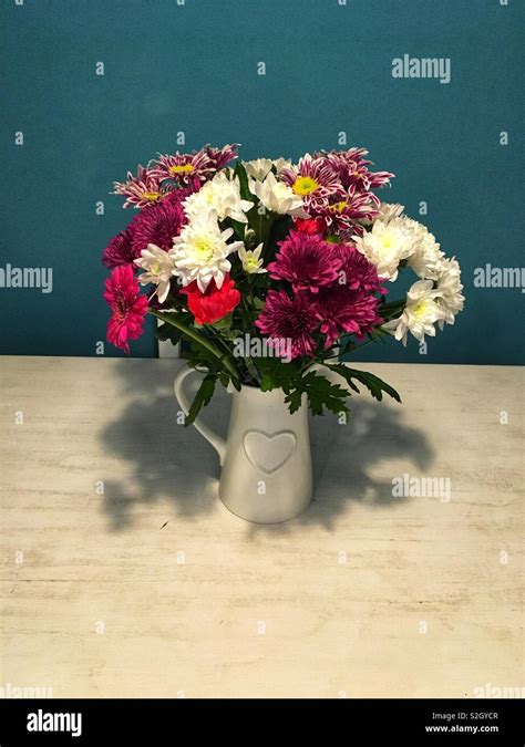 Flowers in jug vase Stock Photo - Alamy