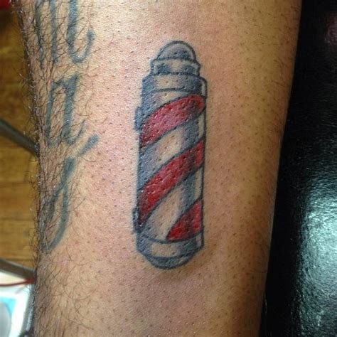 Barber pole tattoo located on the shin, traditional