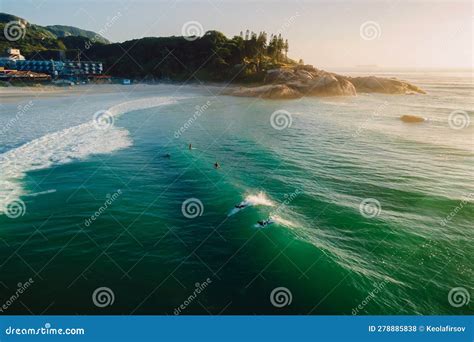 Sunrise On Ocean With Surfers On Wave Joaquina Beach In Brazil