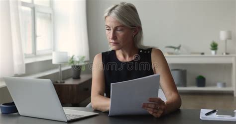 Mature Business Woman Taking Off Her Black High Heels After A Long Day