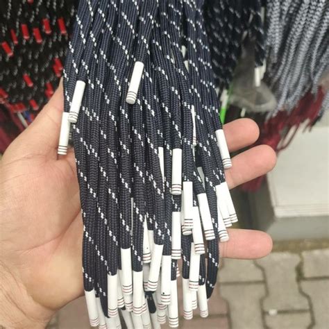 A Hand Holding Several Black And White Cables