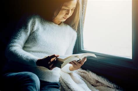 Premium Photo Woman Reading Book While Sitting In Train