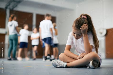 Sad Schoolgirl Feeling Left Out During Physical Activity Class At