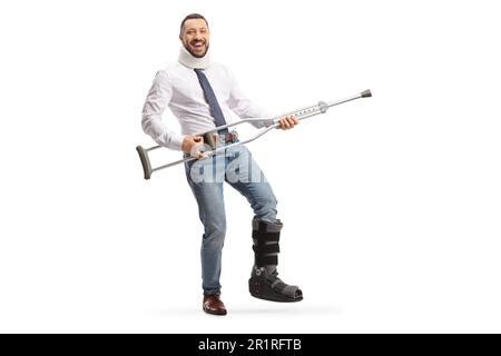 Happy Man With A Cervical Collar And Orthopedic Boot Lifting Crutches