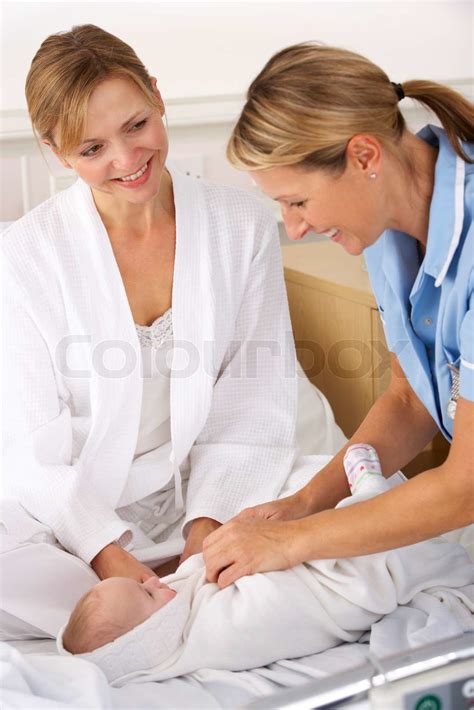 Nurse with mother and newborn baby | Stock image | Colourbox