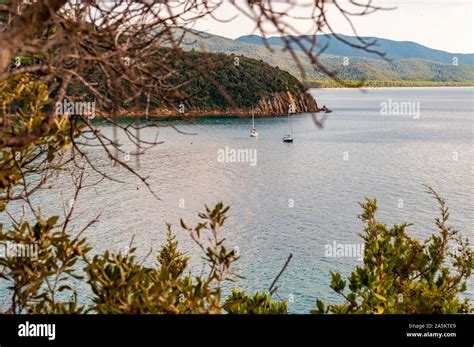 Two Yahts Floating Near The Scenic Landscape Of Cala Violina Beach In