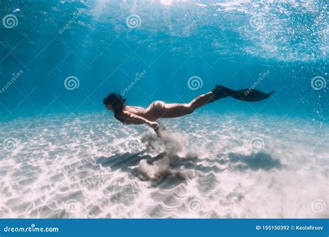 Naked Woman Free Diver Glides Over Sandy Sea With Fins Freediving In