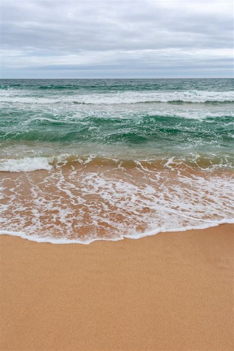 Turquoise Sea With Waves And Sea Foam Sandy Beach Stock Photo Image