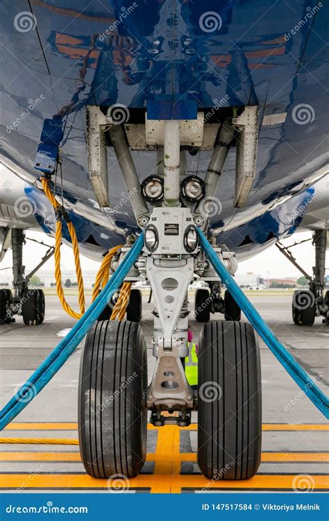 The Front Landing Gear Of The Aircraft Standing On The Refueling At The