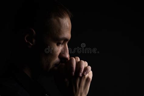 Close Up Of Faithful Mature Man Praying Hands Folded In Worship To God