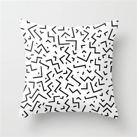 A Black And White Pillow With An Abstract Design On The Front