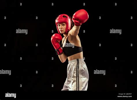 Professional Female Boxer In Boxing Gloves And Helmet Training Isolated