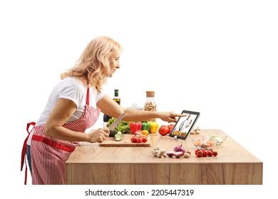 Mature Woman Cooking On Counter Watching Stock Photo 2205447319