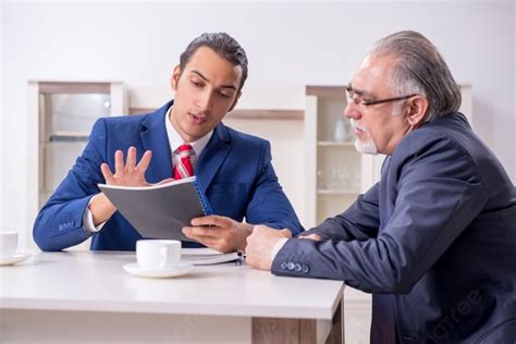 The Two Businessman Discussing Business In Office Two Businessman