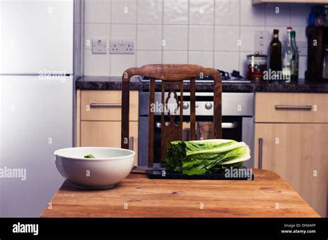 Lettuce and bowl in kitchen Stock Photo - Alamy