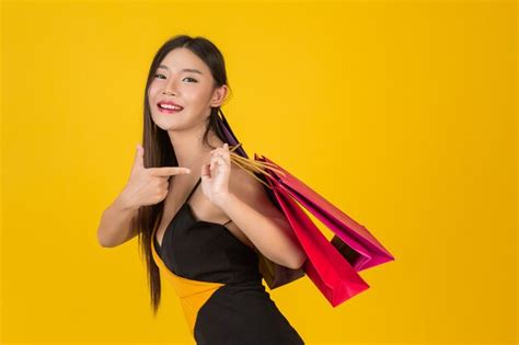 Free Photo Shopping Beautiful Woman Holding A Colorful Paper Bag On A