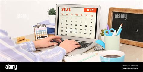 Businesswoman With Laptop Using Calendar Application In Office Stock