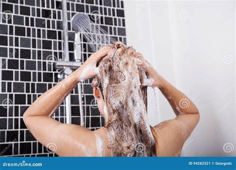 Woman Washing Head And Hair In The Shower By Shampoo Rear View Stock