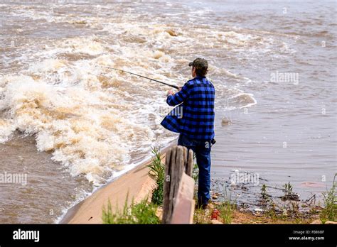 A Man Fishes In The Rising Waters Of Hefner Lake In Oklahoma City After