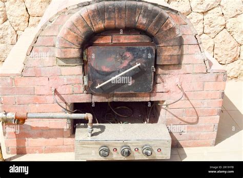 A Large Professional Industrial Brown Stone Oven Grill Oven With A Tube