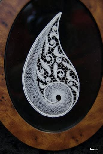 A Black And White Painting On A Wooden Plaque With A Circular Design In