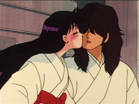 Two People In Kimonos Kissing Each Other With Their Eyes Closed And One