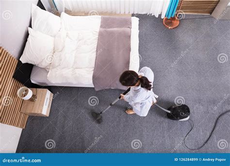 Housekeeper Cleaning Carpet With Vacuum Cleaner Stock Image Image Of