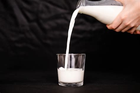 Premium Photo Pouring Fresh Milk Into The Glass