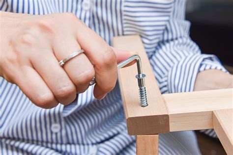 Woman Hands Assembling Wooden Furniture With Tools During Quarantine