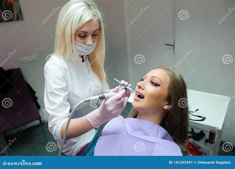 Frightened Woman Sitting In The Dentist`s Chair While Studying The