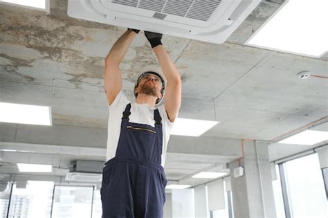 Premium Photo Happy Male Technician Repairing Air Conditioner