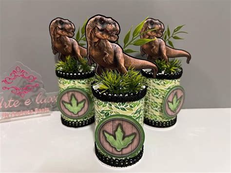 Three Planters With Plants In Them On A Table